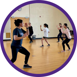 A group doing self-defense moves during a class.